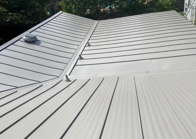 Solar attic fan installed on a metal roof for Roof Ventilation in North Decatur